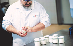 Tate & Lyle scientist demonstrating with jars of yoghurt