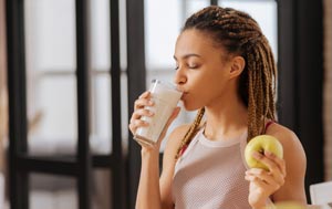 Woman sipping fortified milk drink