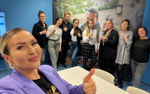 Zuzanna and GSS team giving thumbs up in meeting room