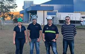 Four colleagues standing in front of Guarani site, Brazil