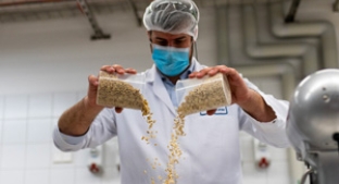 Man pouring ingredients into bowl from a height