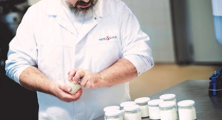 Tate & Lyle scientist demonstrating with jars of yoghurt